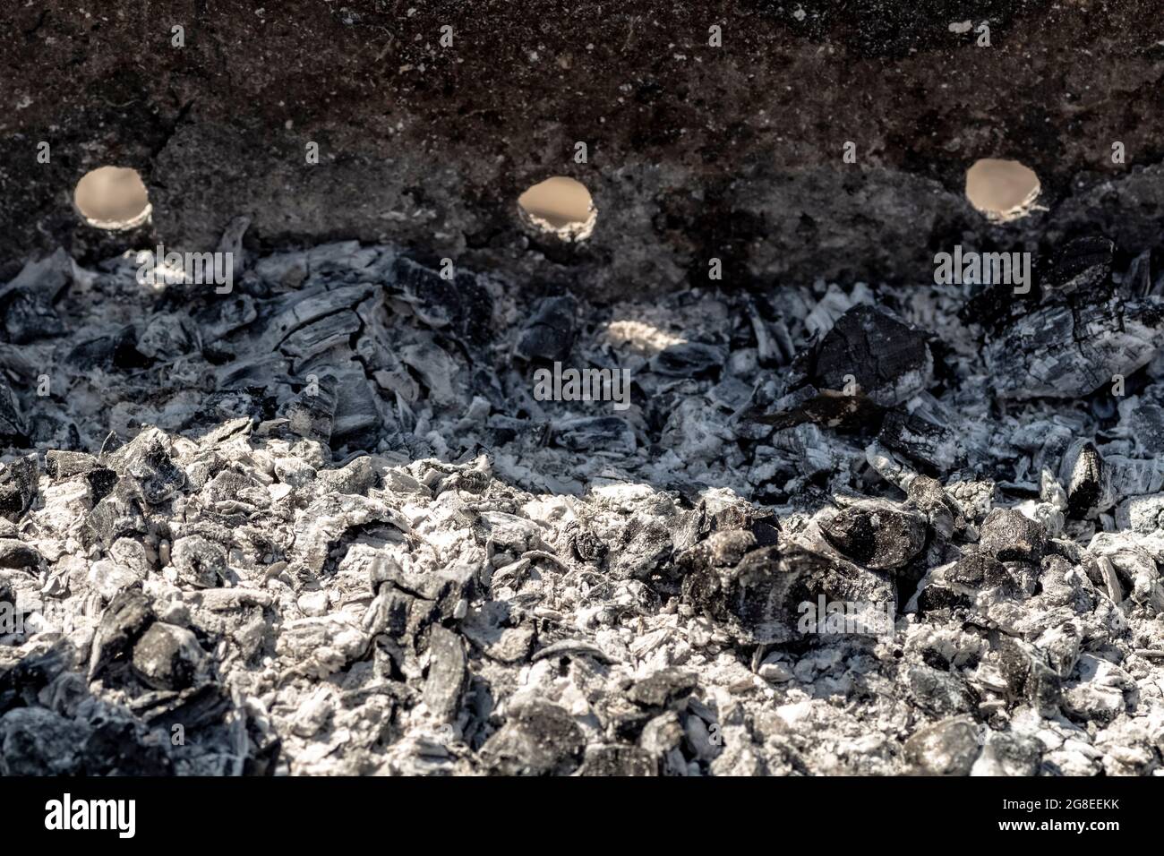 Black burnt coals in the grill close-up. Stock Photo