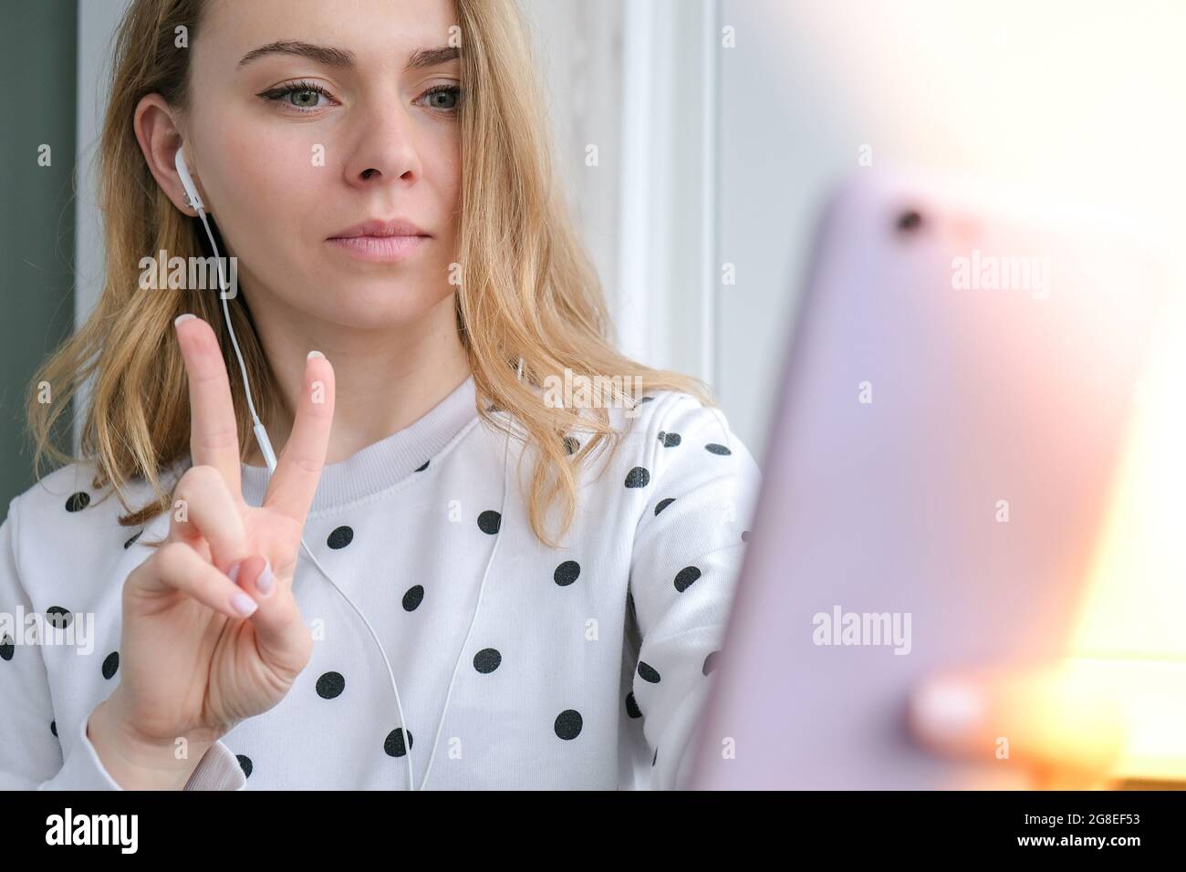 Blonde young girl taking selfie. Video call. Online education. Work from  home. Woman holding smartphone. Phone call. Recording new vlog for her  channel. Blogger Conference Stock Photo - Alamy