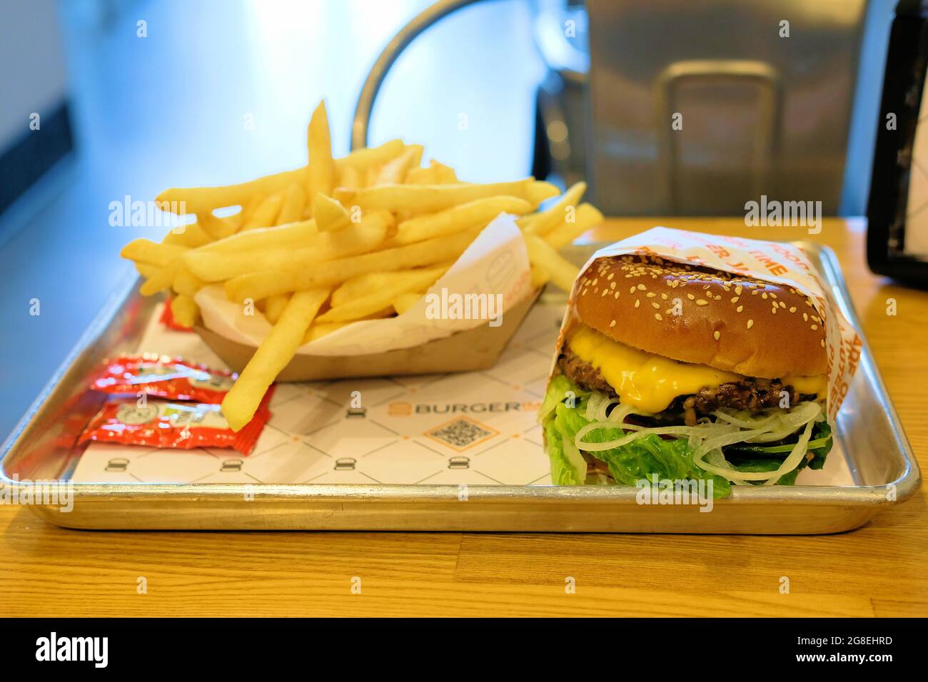 Hamburger and fries on a tray at the Burgerim restaurant; an Israeli fast food hamburger franchise featuring fast-casual gourmet burgers. Stock Photo