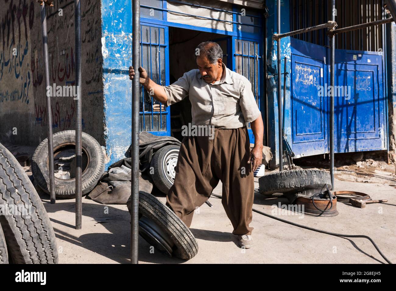 Repairman of local auto repair shop, outskirs of city, Kermanshah, Kermanshah Province, Iran, Persia, Western Asia, Asia Stock Photo