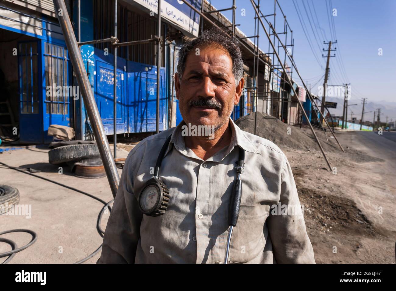 Repairman of local auto repair shop, outskirs of city, Kermanshah, Kermanshah Province, Iran, Persia, Western Asia, Asia Stock Photo