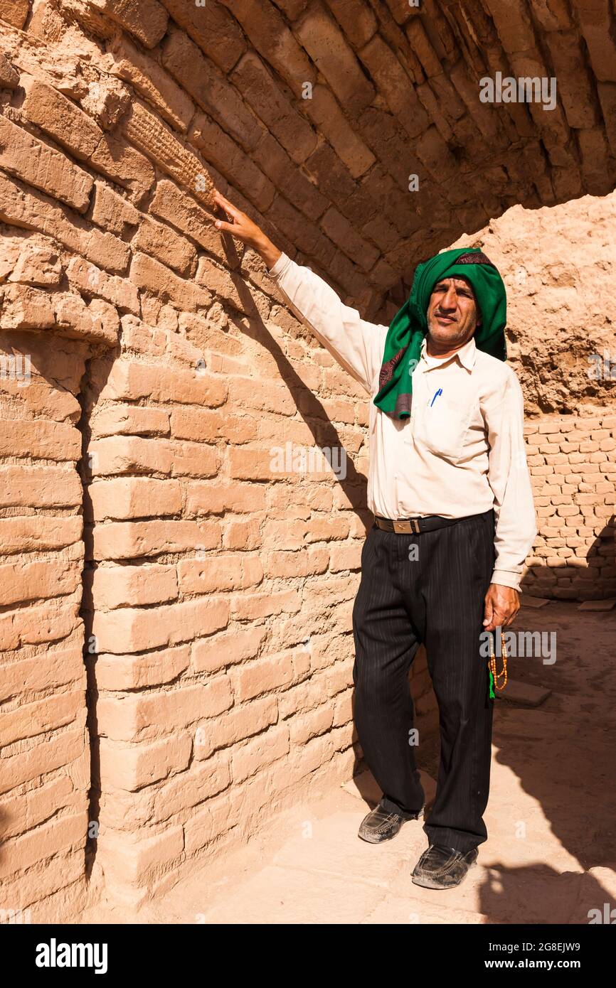 Chogha Zanbil, local guide shows brick with cuneiform inscription, Ziggrat(ziqqrat) of Elamites, Khuzestan Province, Iran, Persia, Western Asia, Asia Stock Photo