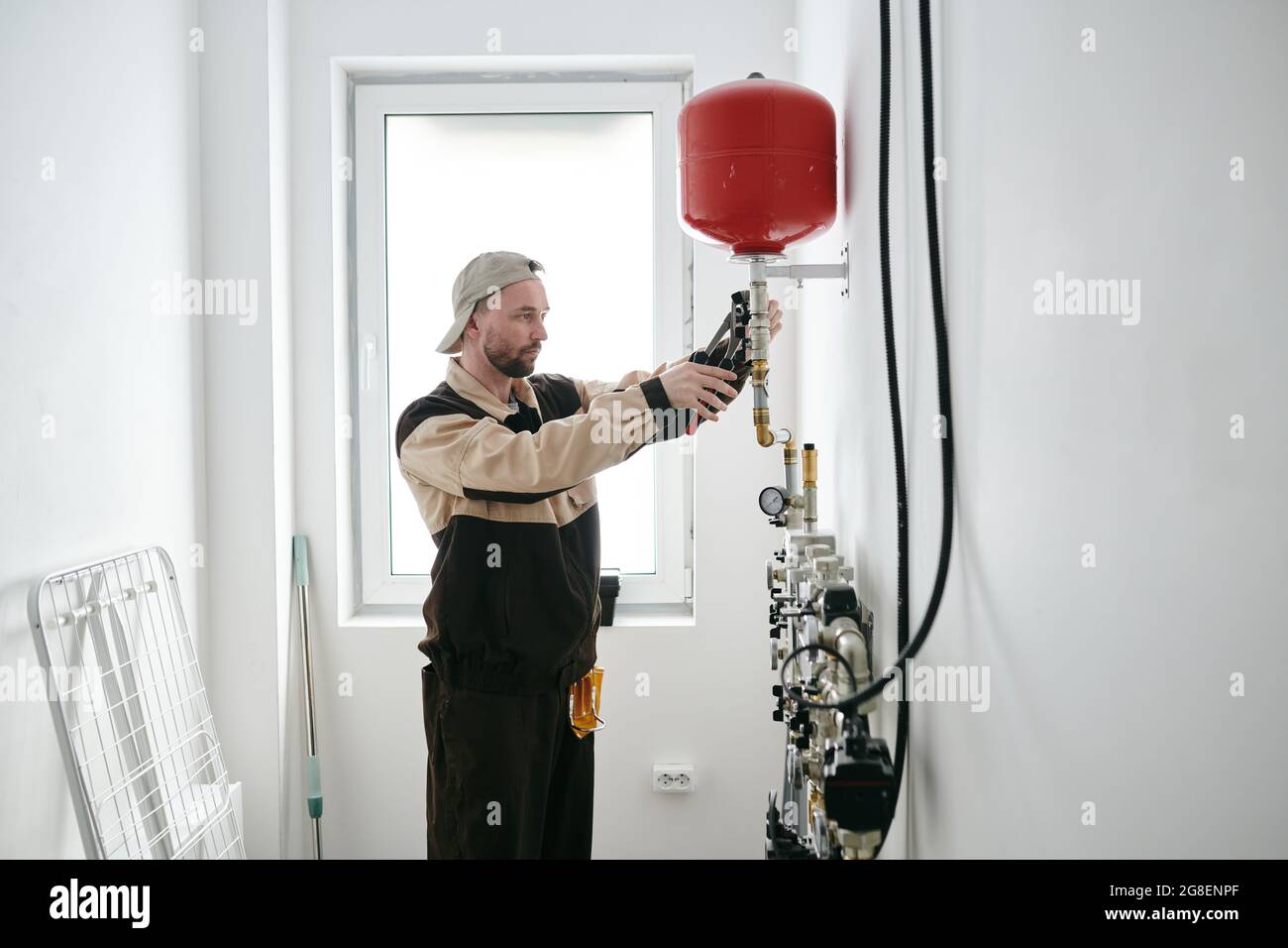Modern plumber fixing new toilet equipment in house or apartment Stock Photo