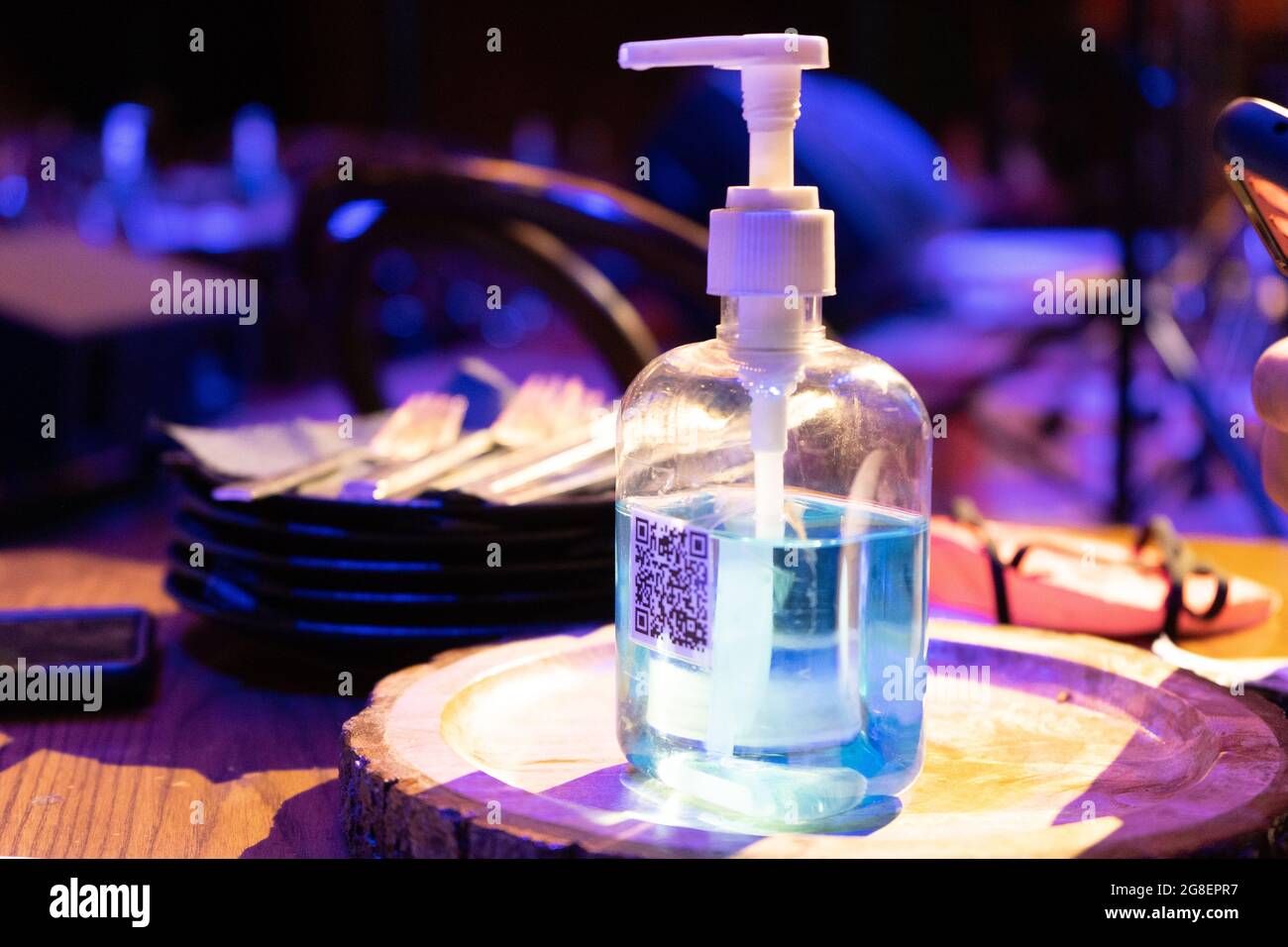 sanitizer bottle with QR code for digital menu being scanned on mobile ...