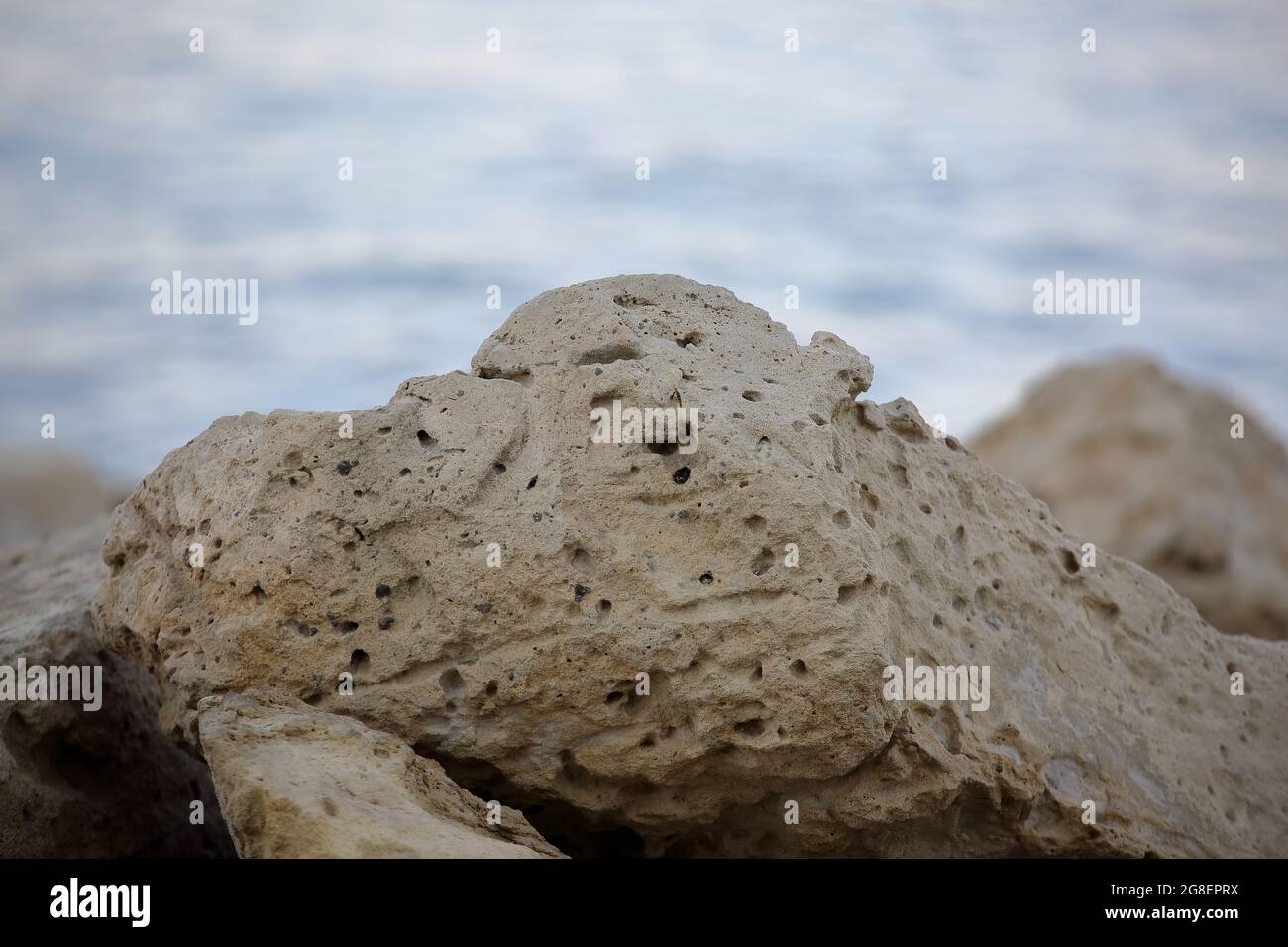 Rock on the beach in Limassol, Cyprus, in background blurry Mediterranean sea Stock Photo
