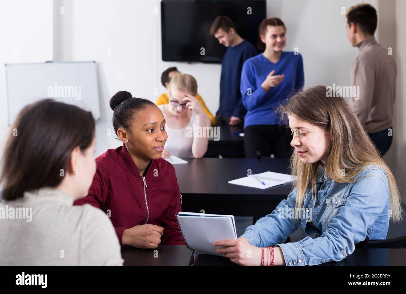 joyous classmates having animated talks at break between classes Stock ...