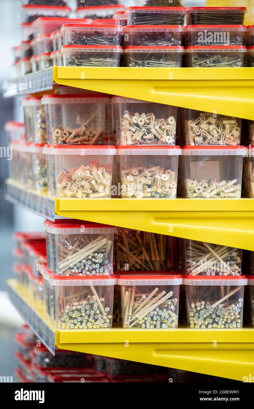 Various types of nails in plastic containers on shelves Stock Photo Alamy