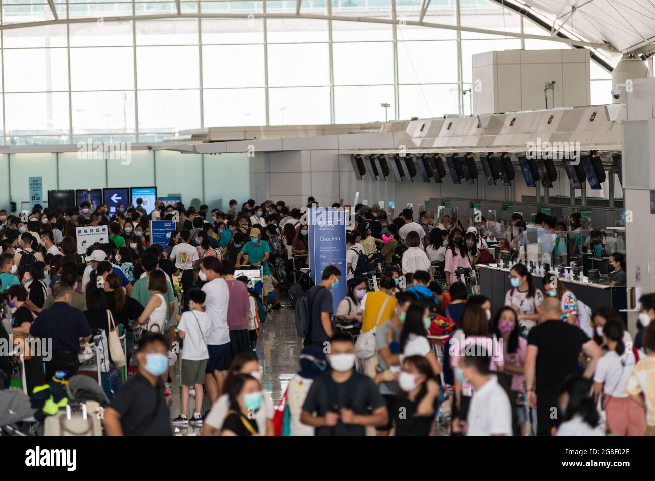 Hong Kong, China, 17 Jul 2021, The crowd queuing for check-in at the British Airways counters contrasted with all other destinations. Stock Photo