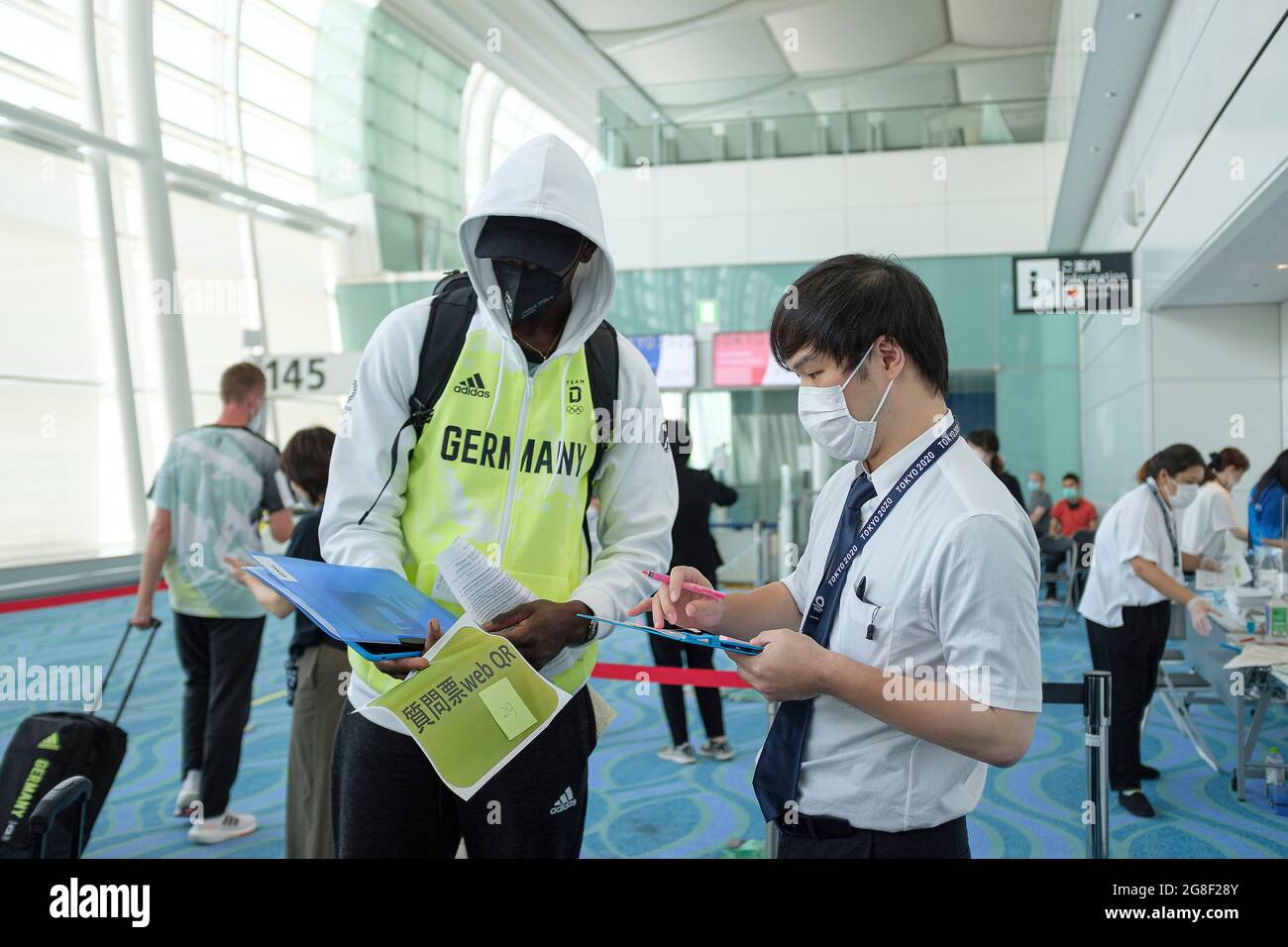A helper helps basketball player Isaac BONGA (GER) at Haneda Airport, on  July 19, 2021 Summer Olympics 2020, from July 23. - 08.08.2021 in  Tokyo/Japan. Â Stock Photo - Alamy