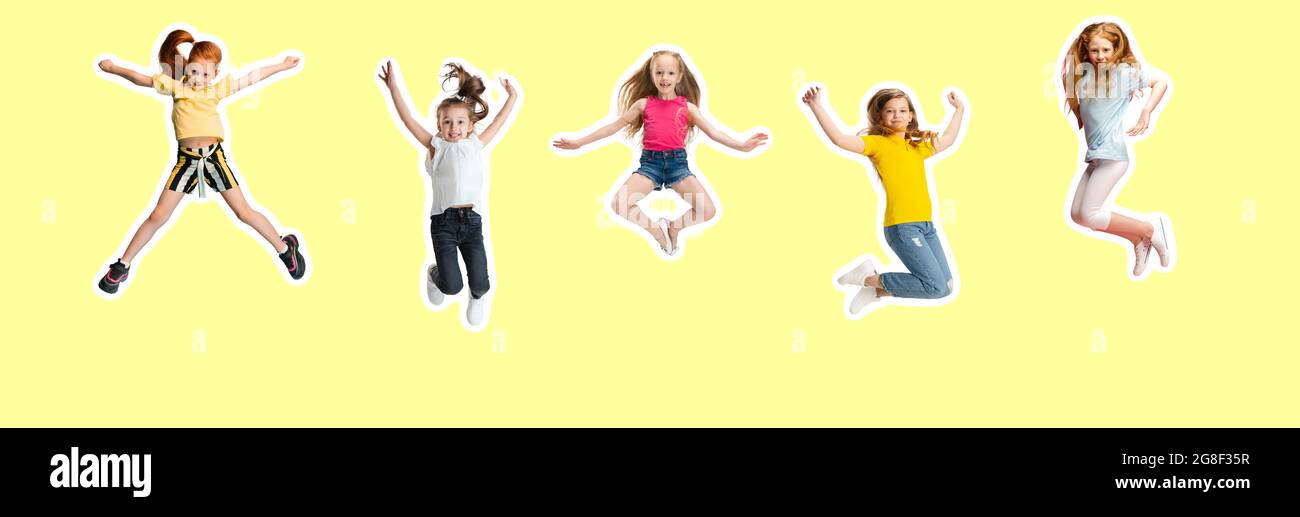 Art collage made of little and happy kids jumping isolated on yellow studio background. Human emotions, facial expression concept Stock Photo