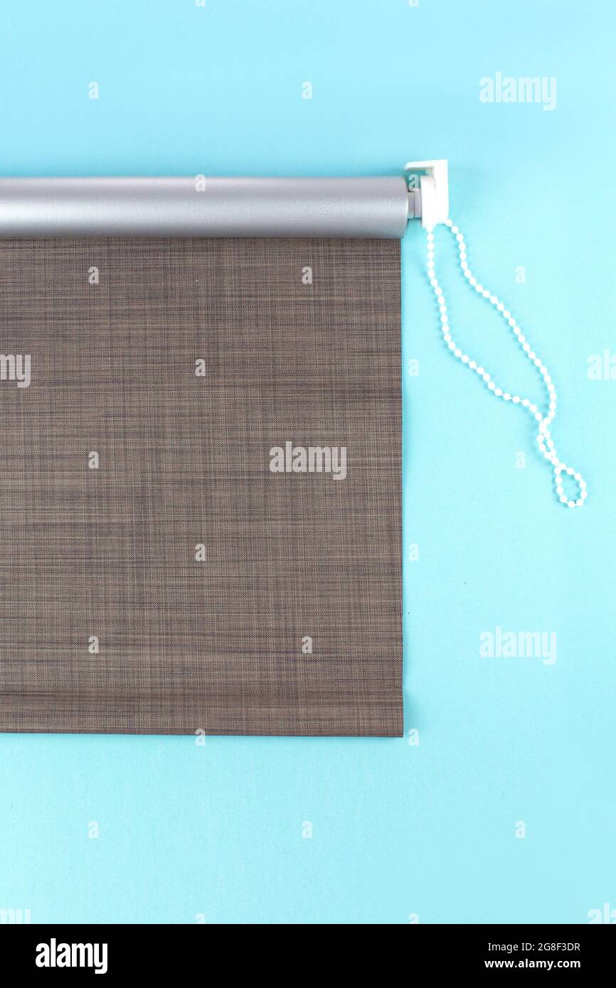 Roller blinds are made from texture material. Color blackout roller blind. Stock Photo