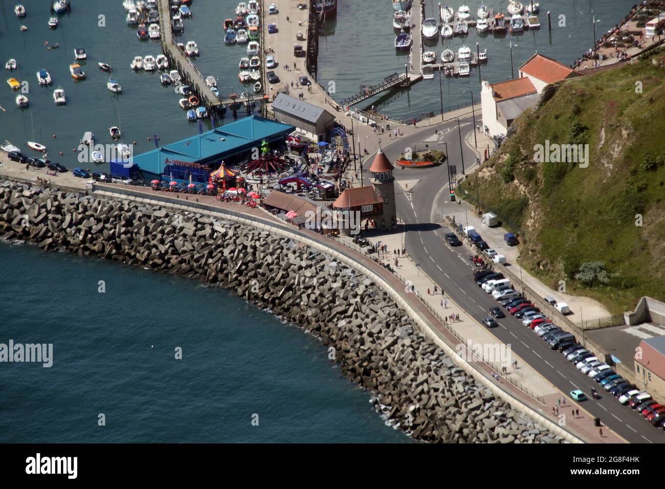 Aerial photo of the Toll Gate at the start of the Marine Drive in Scarborough showing rock armour defence, the fun fair and part of the 2 harbours Stock Photo