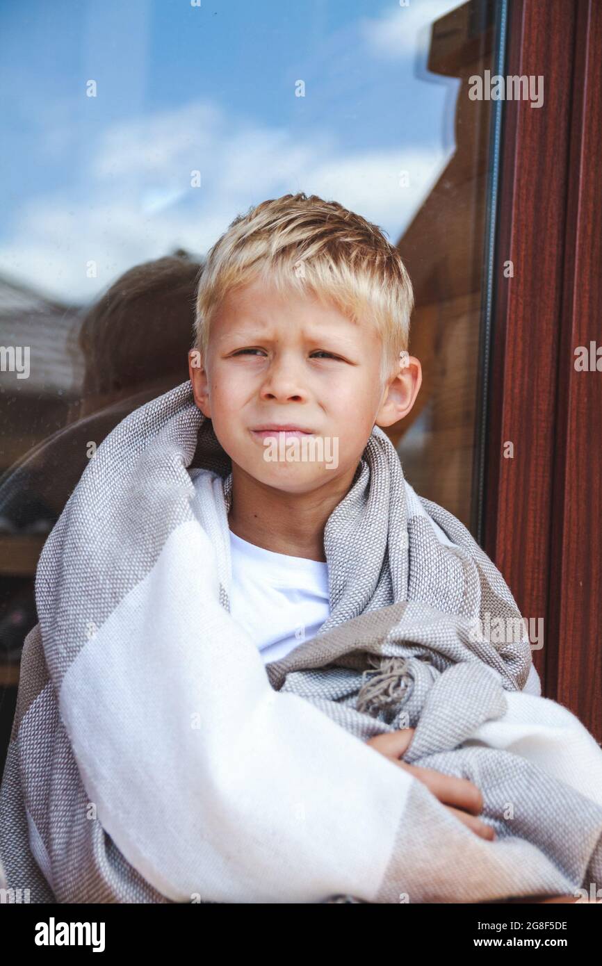  Cute boy sitting in a cozy blanket outdoors Stock Photo - Alamy
