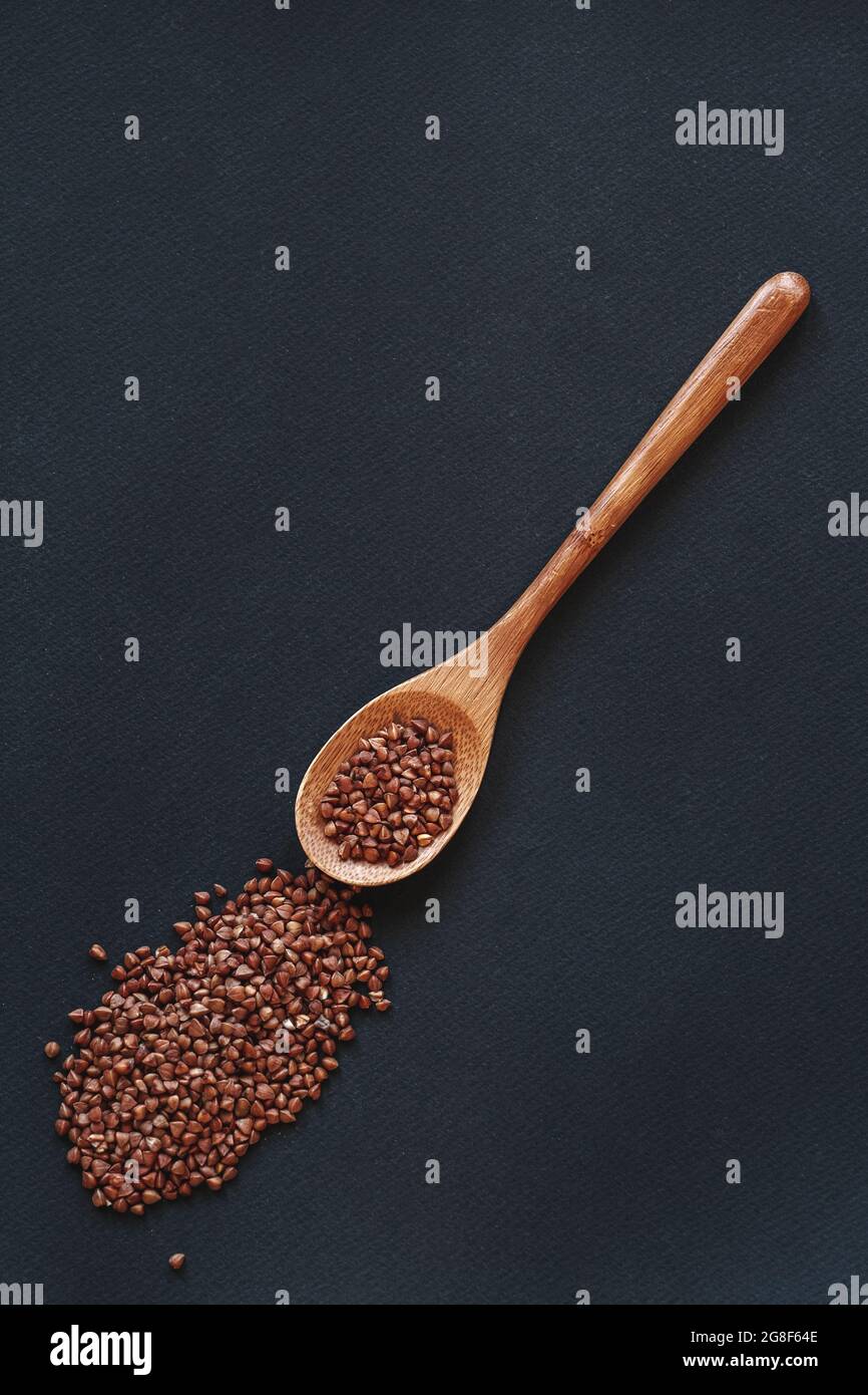 A cereals buckwheat in wooden or bamboo spoon top view Stock Photo