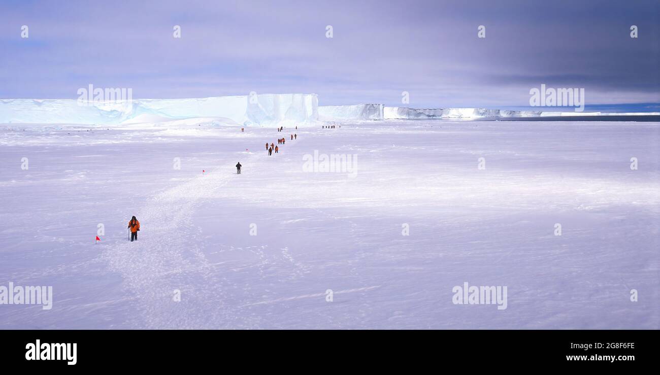 Tourists walking an an ice floe, Drescher Inlet Iceport, Queen Maud Land, Weddell Sea, Antarctica Stock Photo