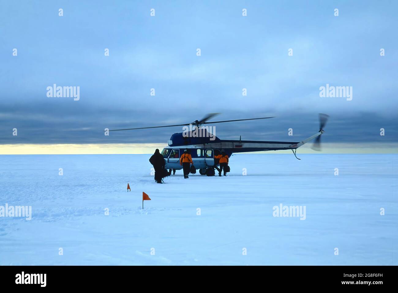 Helicopter loading people on the Ice floe, Drescher Inlet Iceport, Queen Maud Land Coast, Weddell Sea, Antarctica Stock Photo