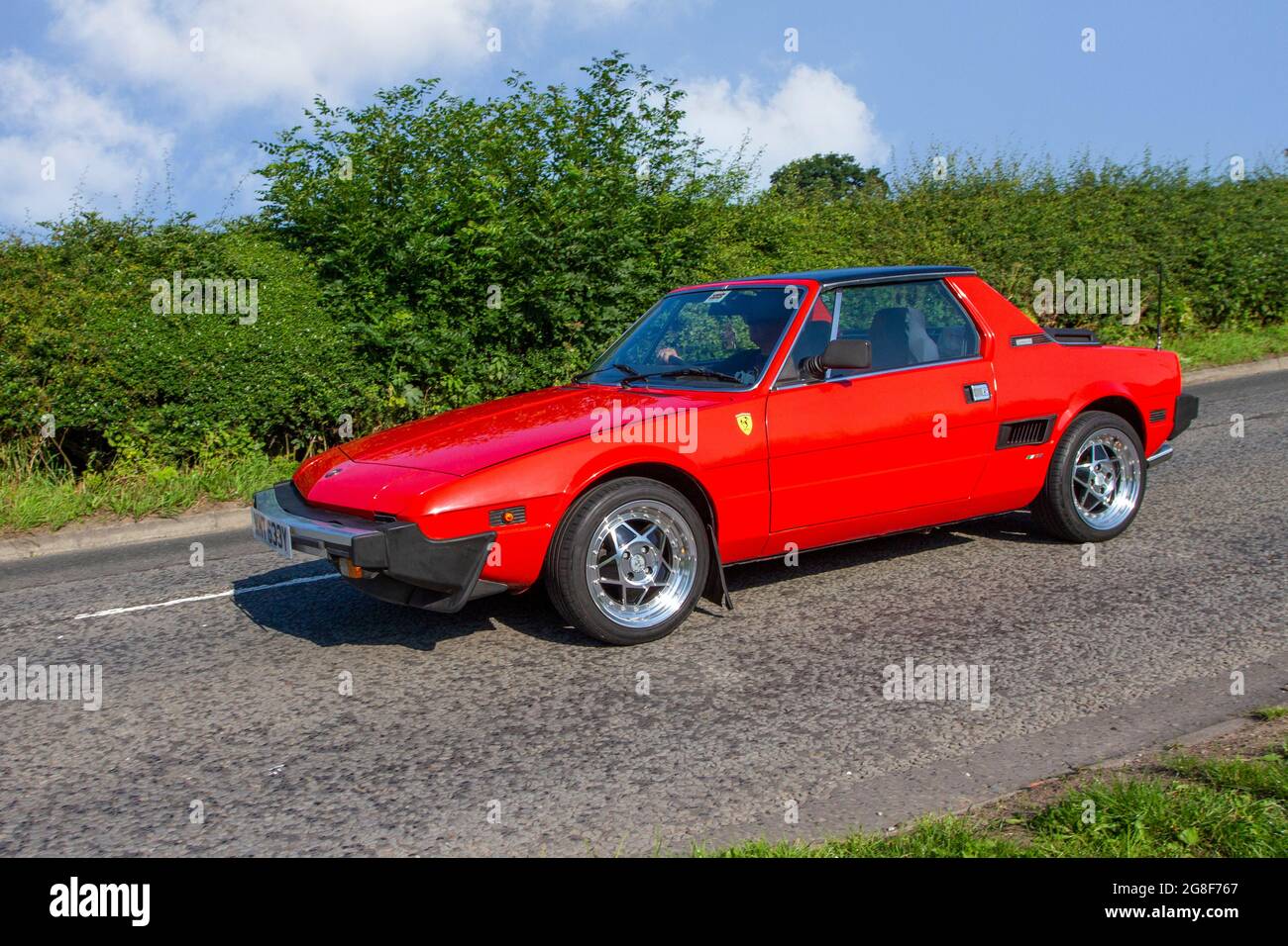1983 80s eighties Fiat X1/9 VS two-seater mid-engined sports car, 2dr coupe, en-route to Capesthorne Hall classic July car show, Cheshire, UK Stock Photo
