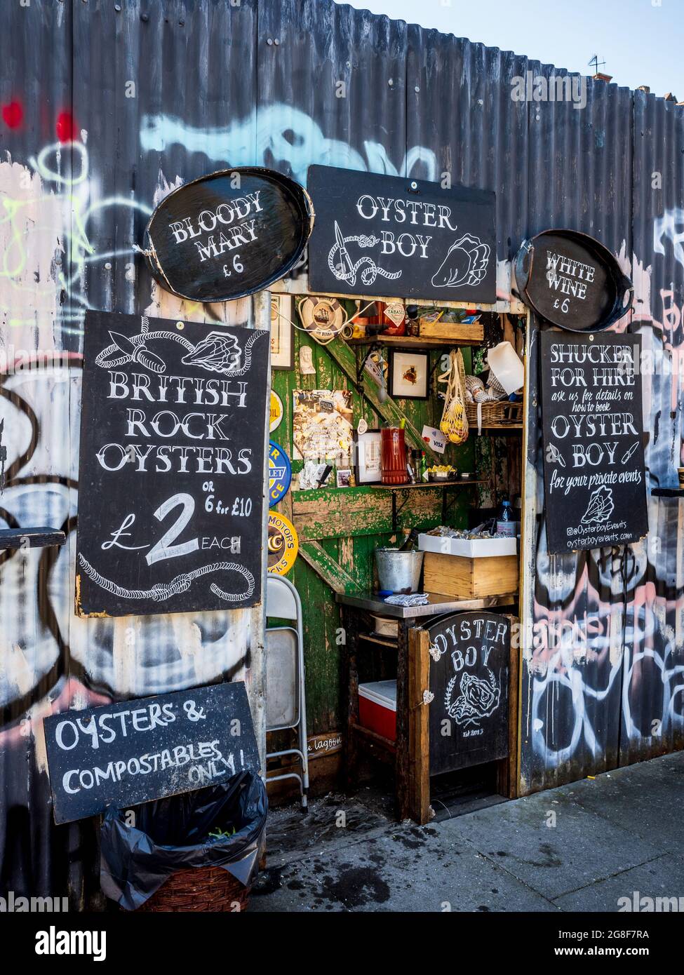 Oyster Boy Columbia Road Sunday Market London Food Stalls - Oyster Boy trades out of a narrow hole in the wall store on Ezra St. serves rock oysters. Stock Photo