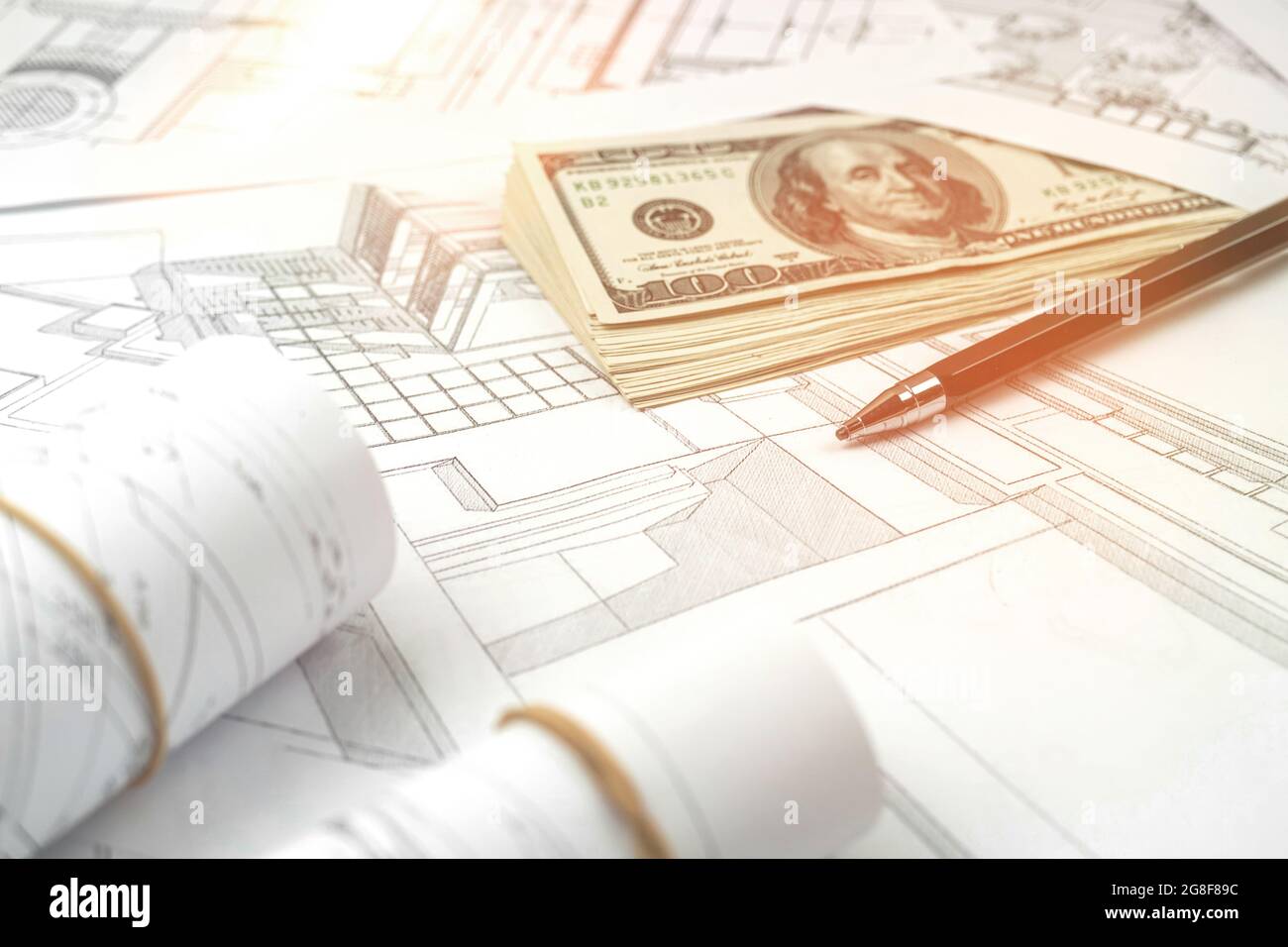 Working on construction project background. Office table with dollars and pen Stock Photo