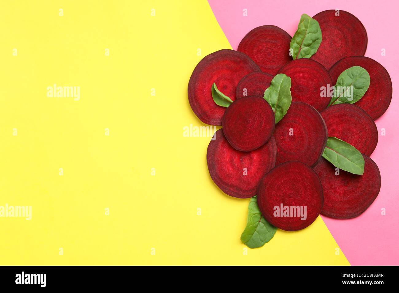 Ripe red beet with leaves on two tone background Stock Photo