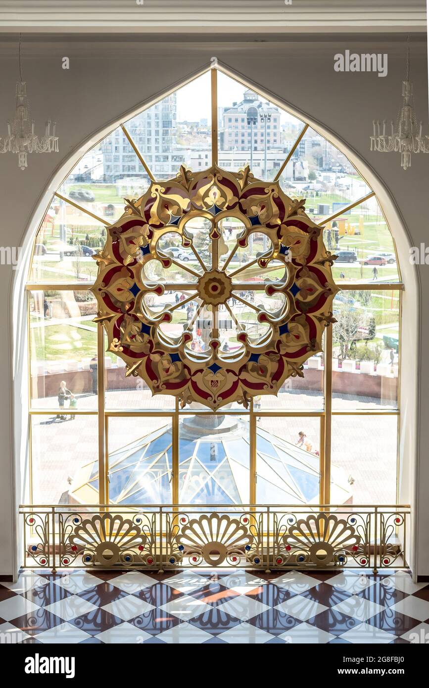 Window with stained glass in empty decorated hall of theater Stock