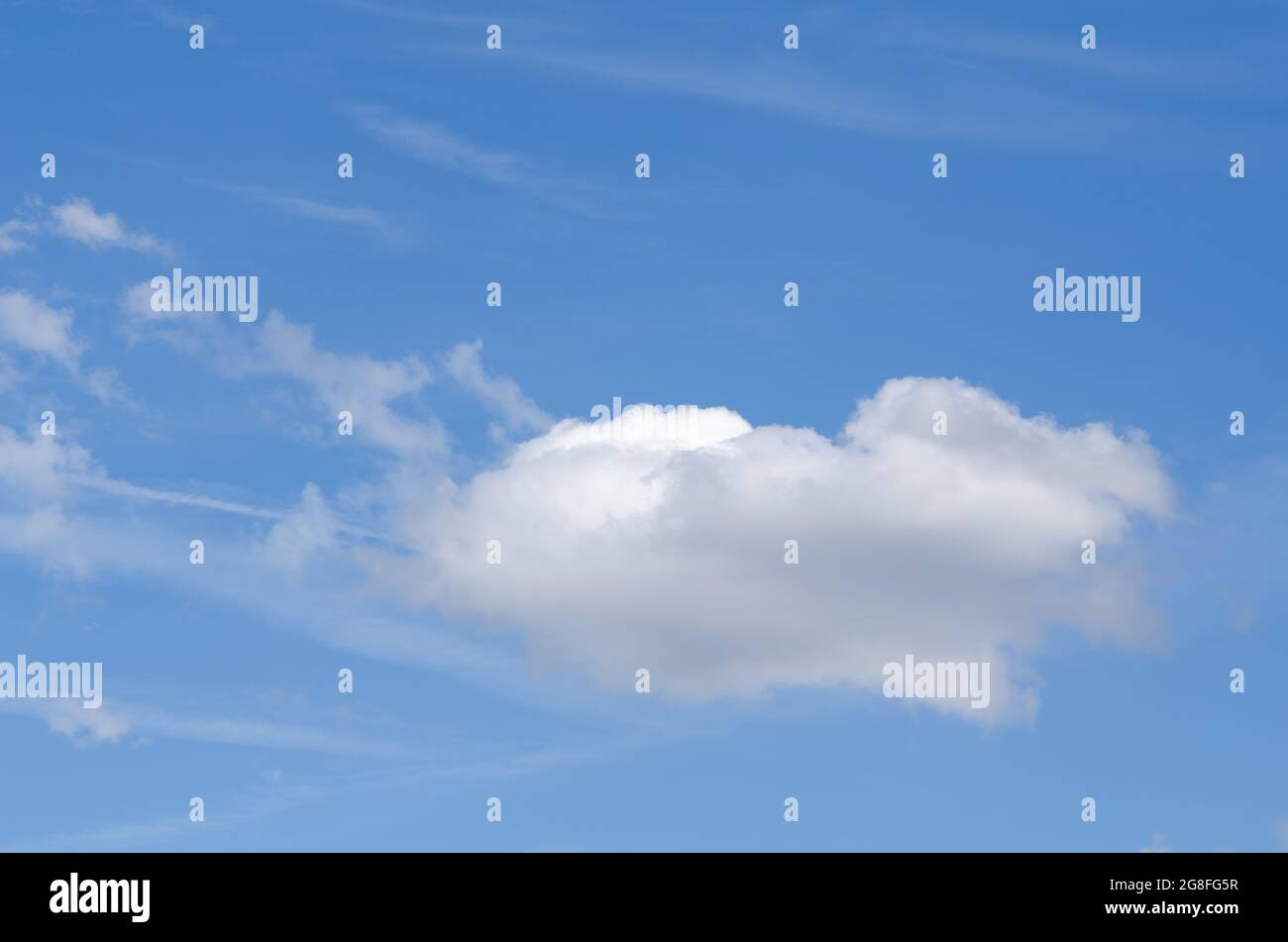 White cumulus clouds against blue sky on a sunny day Stock Photo