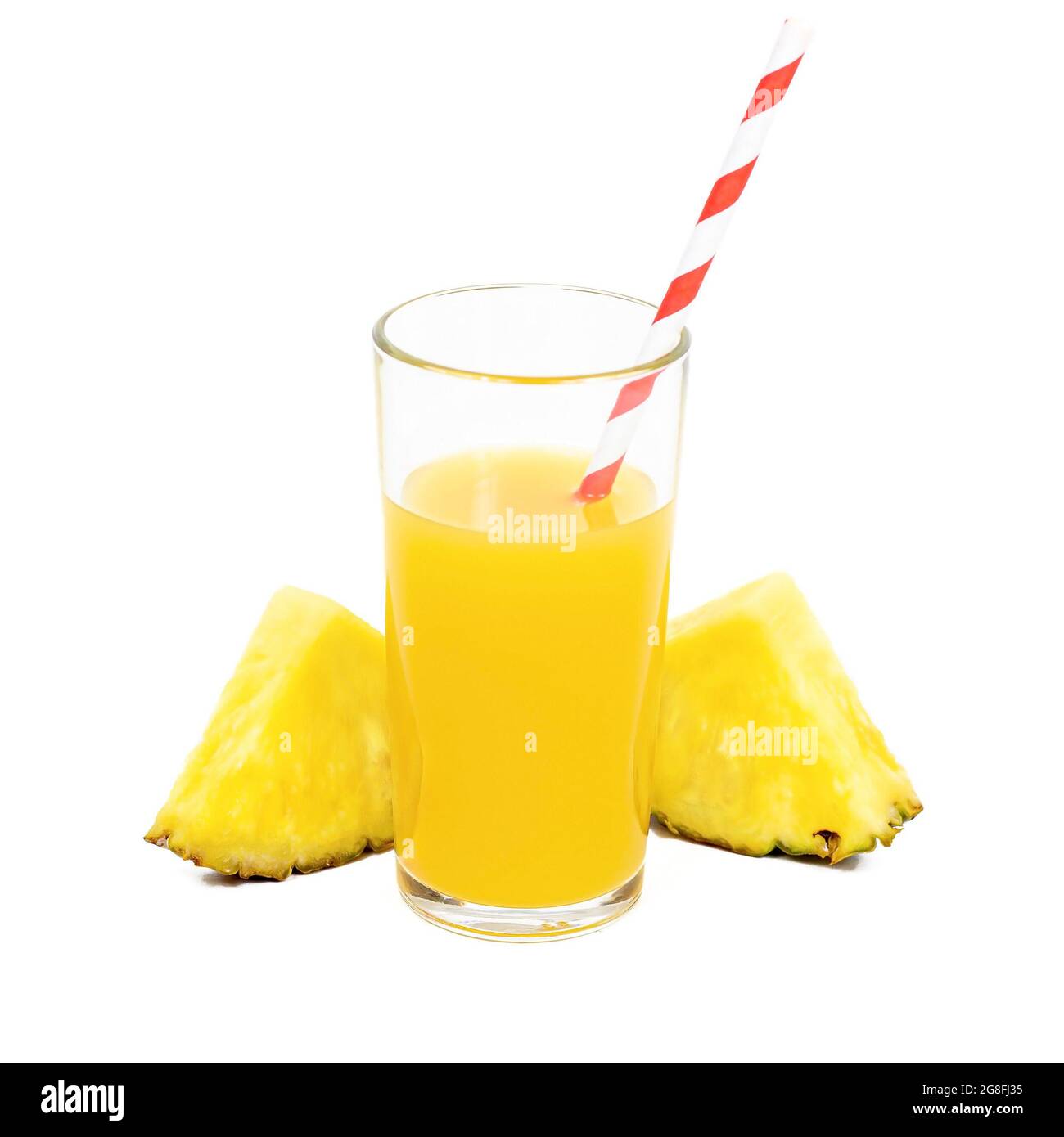 Fresh homemade pineapple juice in a glass with slices and a straw ...