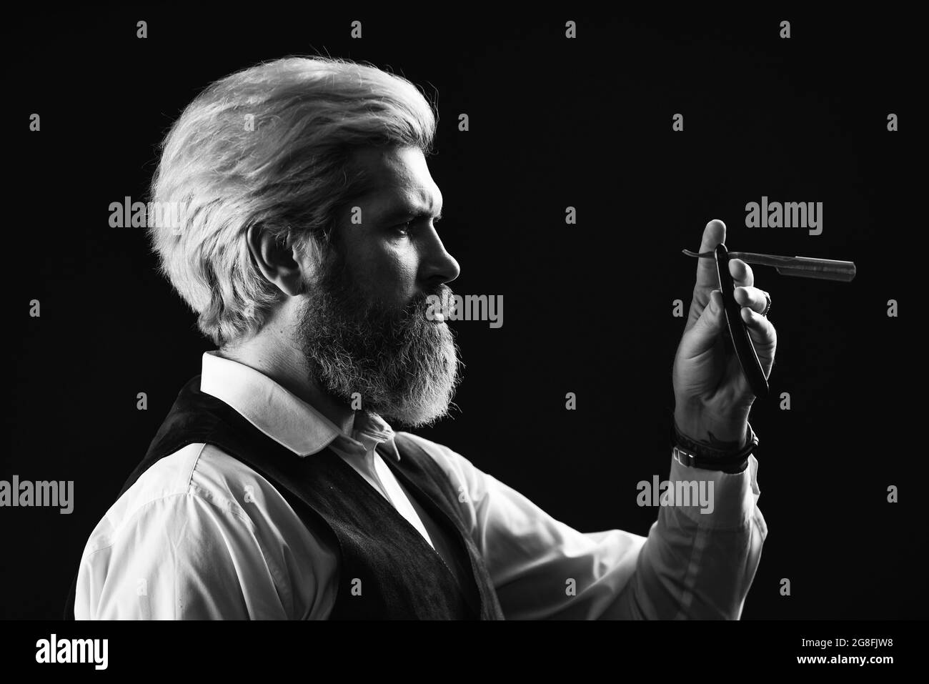 Mens haircut in barber shop. mustache and beard trims. ready to cut his