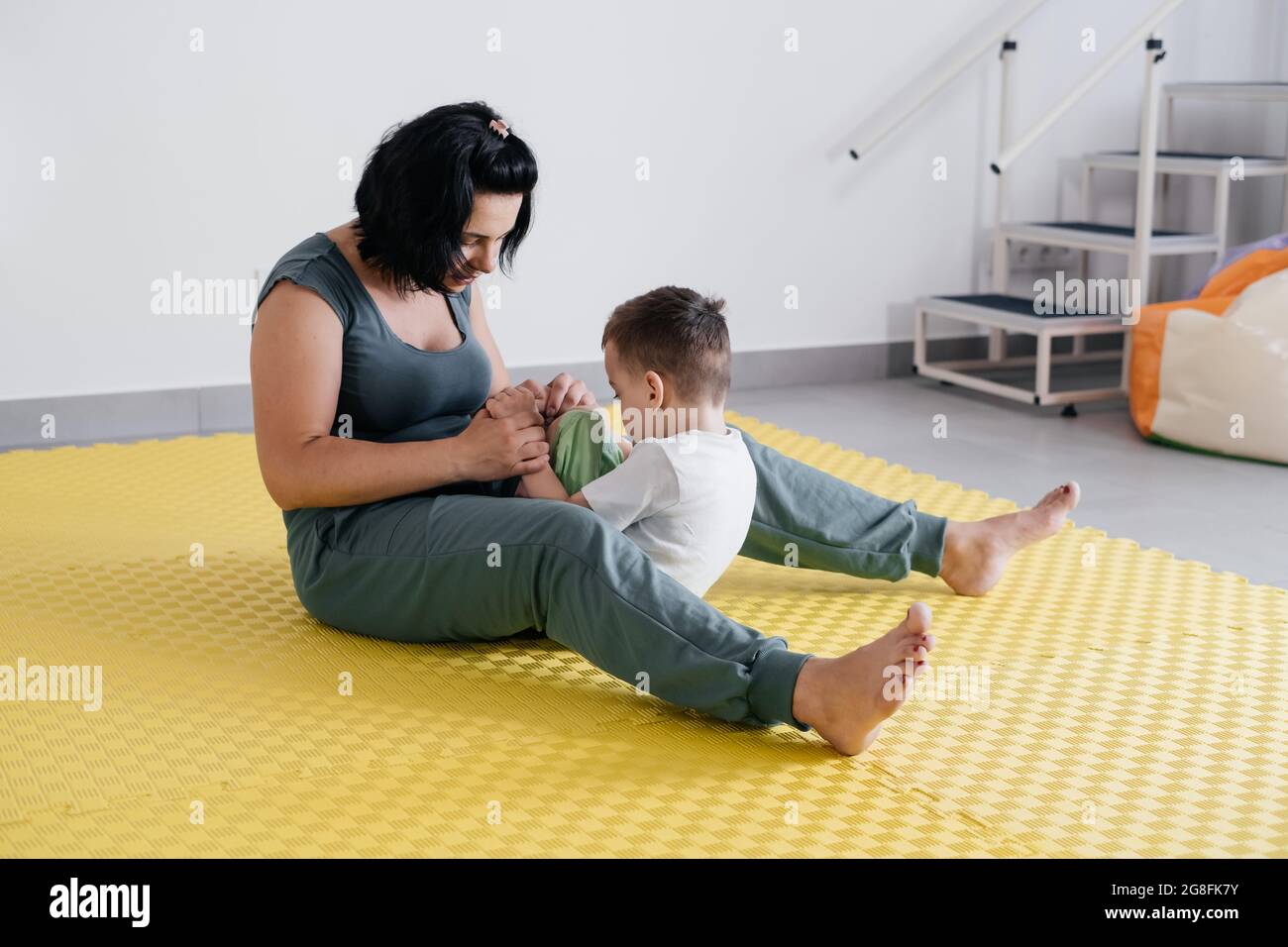 Rehabilitation of child with cerebral palsy in special center. Mother