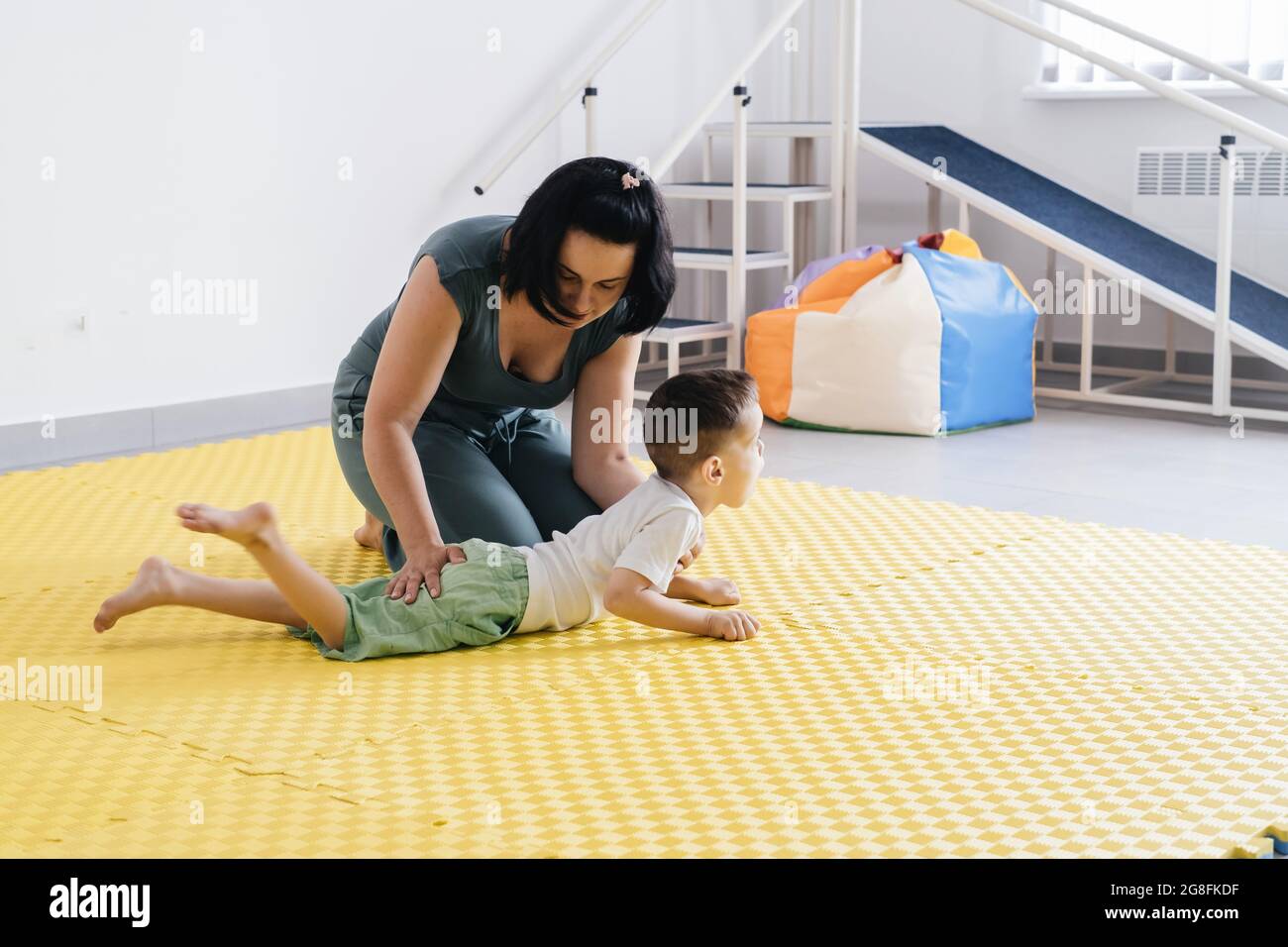 Rehabilitation of child with cerebral palsy in special center. Mother