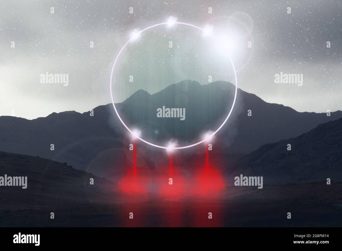 A fantasy concept of a glowing circle portal in the mountains. On a misty spooky winters night Stock Photo