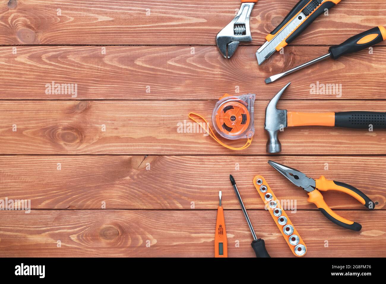 Set of construction tools on a wooden background. Hammer, wrench, pliers and screwdriver. Frame for the holiday Labor Day, Father's Day. Equipment, wo Stock Photo