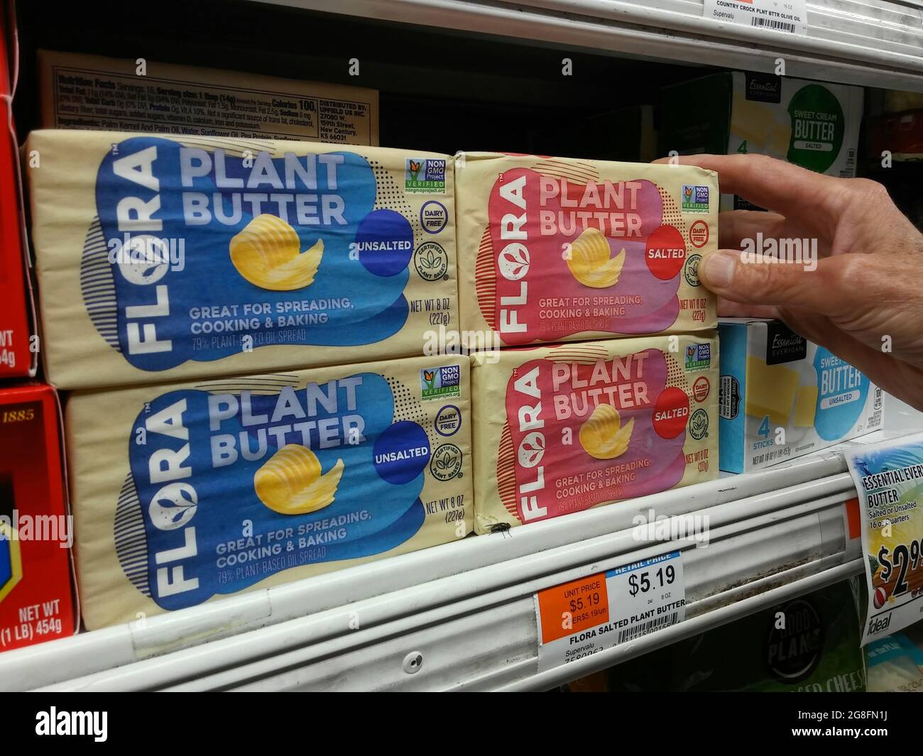 A shopper chooses a package of Flora brand plant-based butter in a cooler in a supermarket in New York on Monday, July 12, 2021.  (© Richard B. Levine) Stock Photo