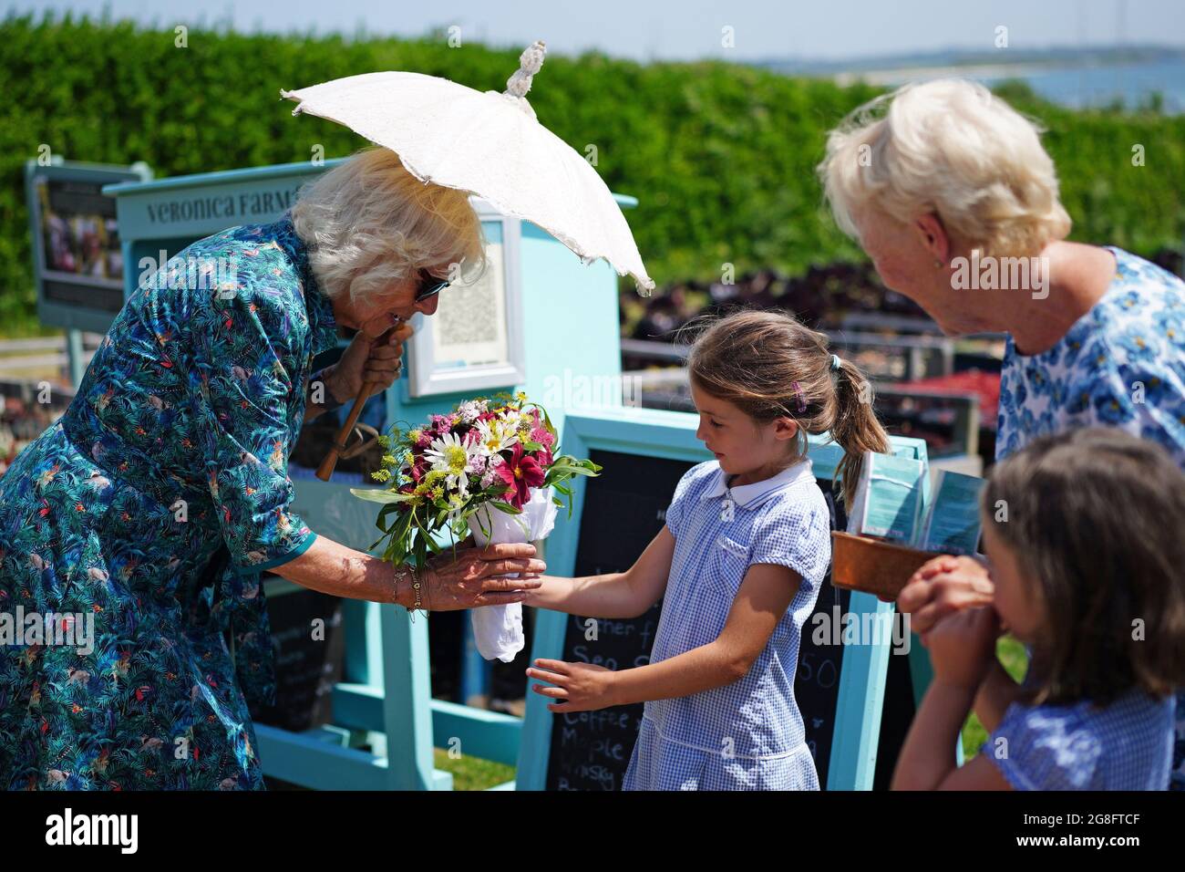 Cordelia Tibbs gives the Duchess of Cornwall flowers during her visit