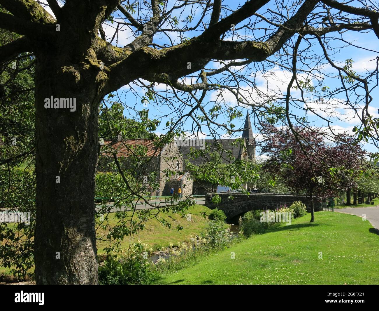 View of Dollar Parish Church taken from West Burnside with the bridge over the little stream flowing from Dollar Glen in the Ochils. Stock Photo