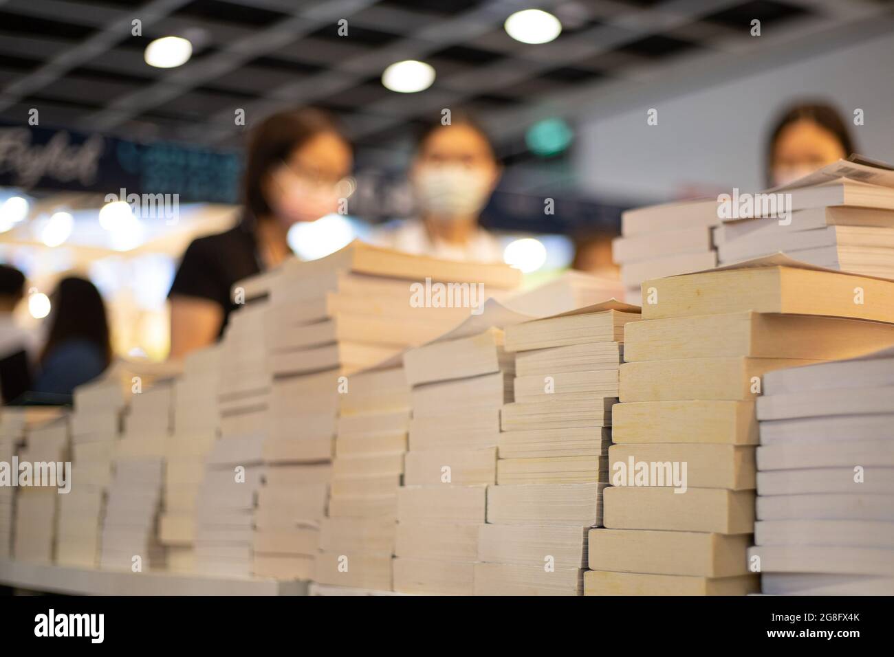 People with face masks read and buy books in Hong Kong Book Fair in