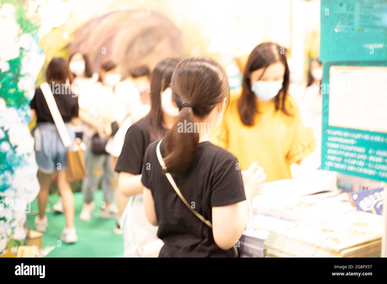 People with face masks read and buy books in Hong Kong Book Fair in