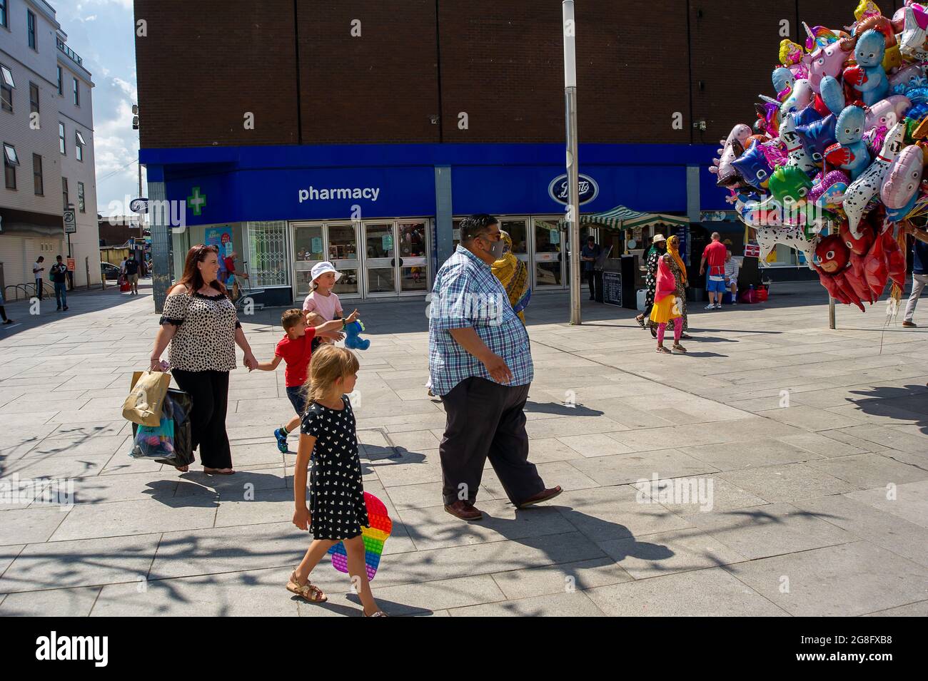 Slough, Berkshire, UK. 20th July, 2021. A lot of shoppers in Slough today were still wearing face masks although it is no longer a legal requirement in shops since the lifting of the Covid-19 Lockdown measure yesterday. Postive Covid-19 cases continue to risk putting a severe strain on the NHS. Credit: Maureen McLean/Alamy Live News Stock Photo