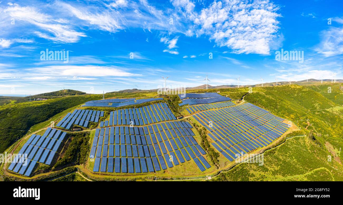 Solar panels and wind turbines on the green plateau, Encumeada, Madeira ...
