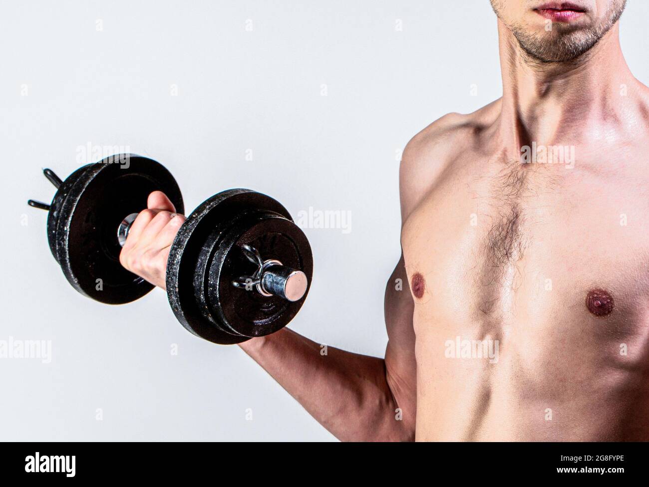 Weak man lift a weight, dumbbells, biceps, muscle, fitness. Nerd  maleraising a dumbbell. Man holding dumbbell in hand. Skinny guy hold  dumbbells up in Stock Photo - Alamy