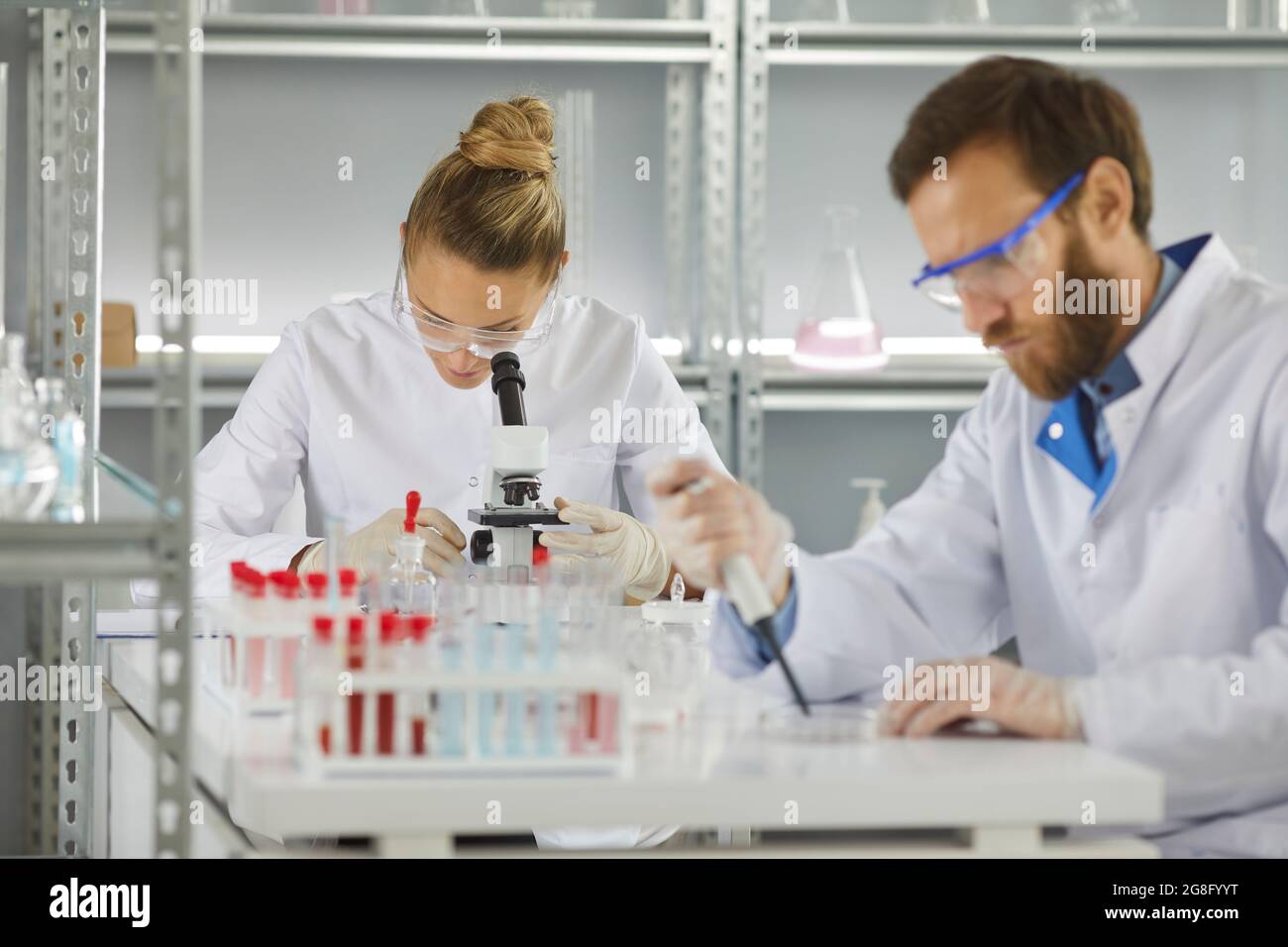 Health researchers diverse team working in biological science laboratory Stock Photo