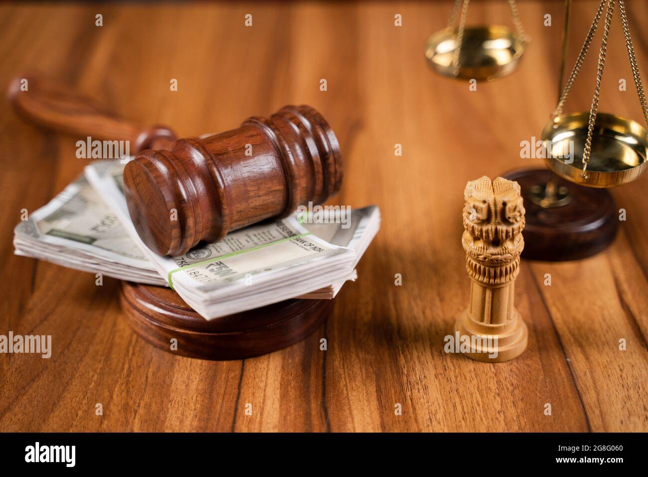 Concept showing of judicial corruption by hitting judge gavel on currency note bundles. Stock Photo