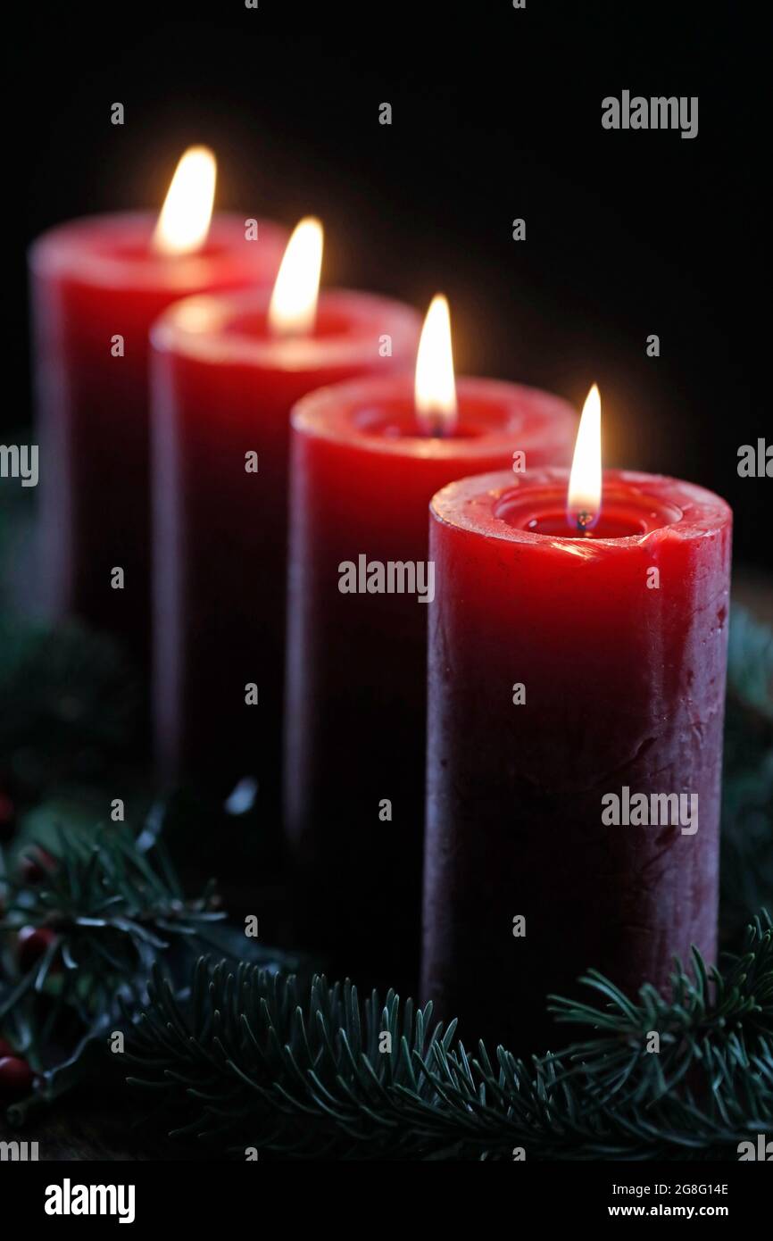 Natural Advent wreath or crown with four burning red candles, Christmas composition, France, Europe Stock Photo