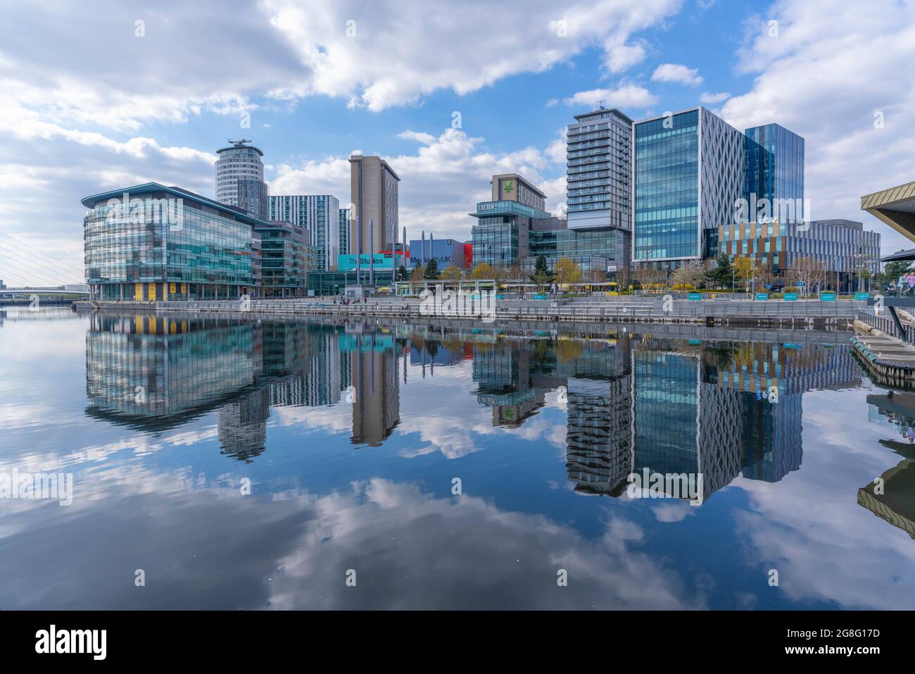 View of MediaCity and clouds reflecting in water in Salford Quays, Manchester, England, United Kingdom, Europe Stock Photo