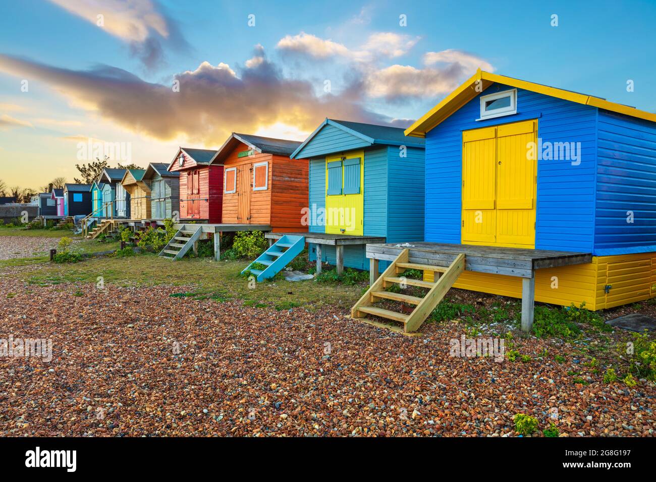 Colourful beach huts on shingle beach at sunrise, Whitstable, Kent, England, United Kingdom, Europe Stock Photo