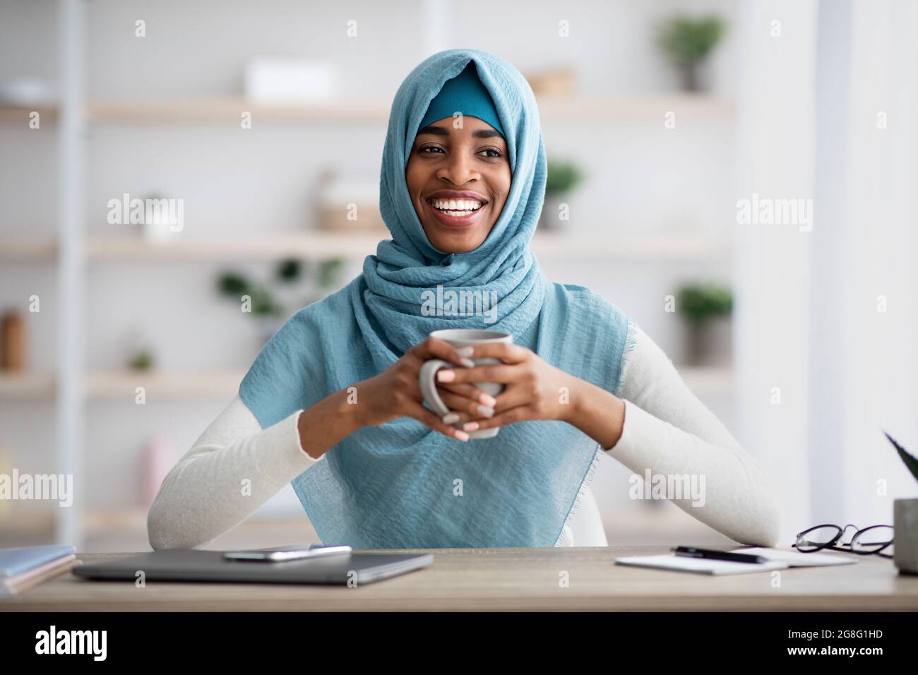 Break At Work. Happy Black Muslim Lady In Hijab Drinking Coffee At ...