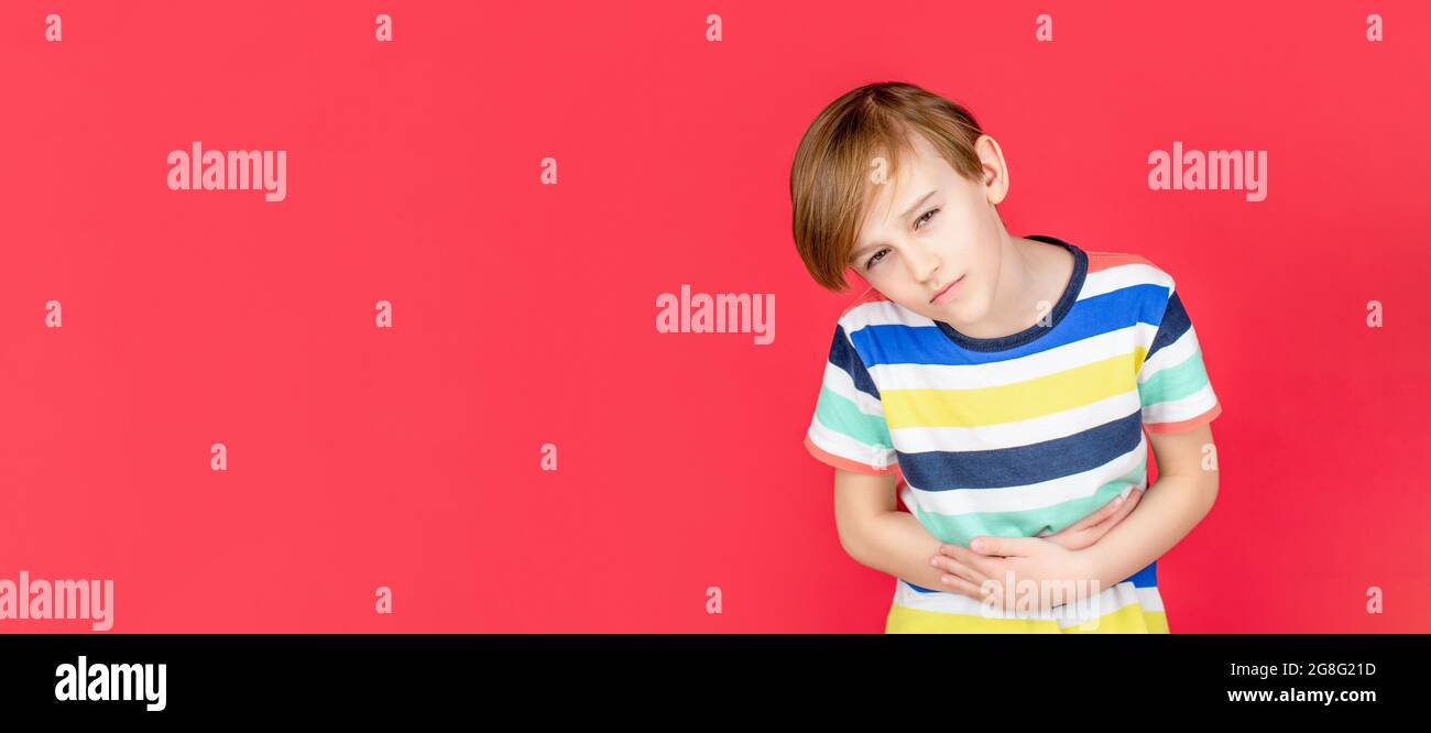 Stomach pain. Teen boy with stomachache. Child having terrible pain in stomach. Diarrhea or gastroenteritis health problem. Child has stomachache with Stock Photo