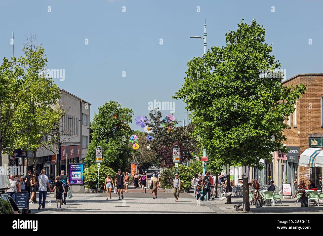 Plymouth’s Cornwall Street. Shoppers returning but sicial distancing mid July 2021. Trees bring colour to the wide pedestrianised shopping area. Stock Photo