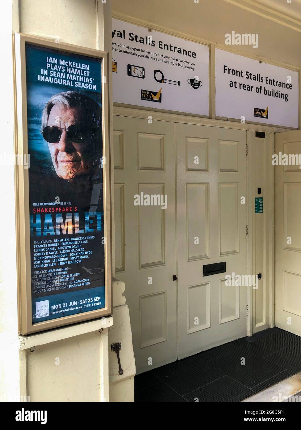 Royal Stalls entrance to the Theatre Royal Windsor, England displaying a poster for HAMLET by Shakespeare starring Sir Ian McKellen as the Danish Prince, running from June to September 2021. Directed by Sian Mathias and produced by Bill Kenwright this is a reimagined age, colour blind and gender blind production. Stock Photo