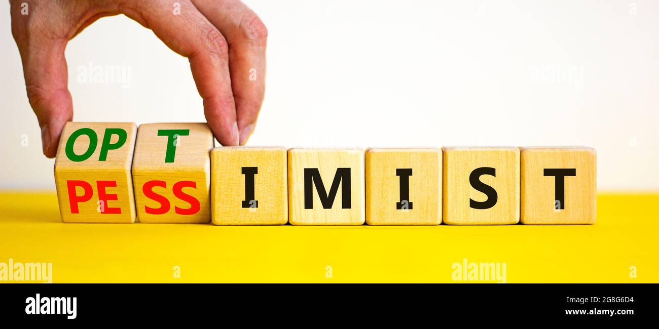 Pessimist or optimist symbol. Businessman turns cubes and changes the word  'pessimist' to 'optimist'. Beautiful yellow table, white background. Busine  Stock Photo - Alamy, image size:1300x650